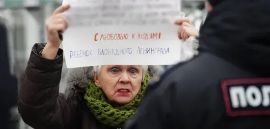 A woman holding an anti-war placard was detained in St Petersburg